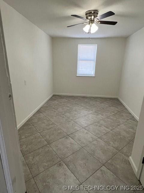 tiled empty room with ceiling fan