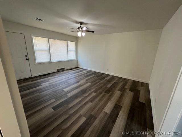 spare room featuring ceiling fan and dark hardwood / wood-style flooring