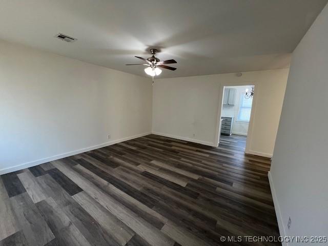 spare room featuring dark hardwood / wood-style floors and ceiling fan