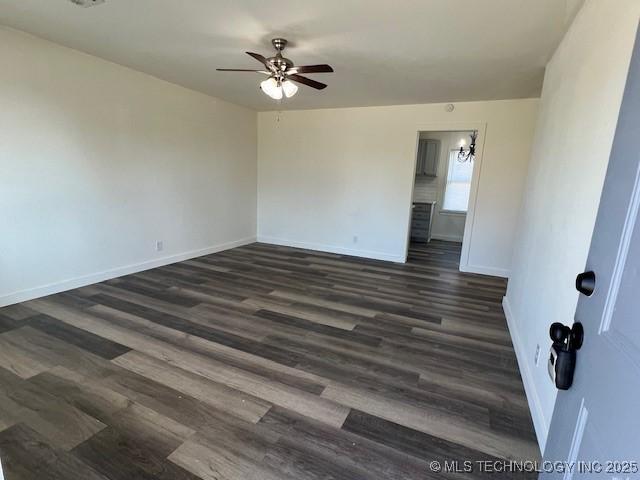 spare room with dark hardwood / wood-style floors and ceiling fan