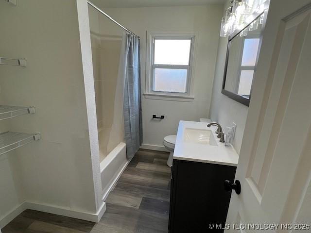 full bathroom featuring hardwood / wood-style floors, vanity, toilet, and shower / bathtub combination with curtain