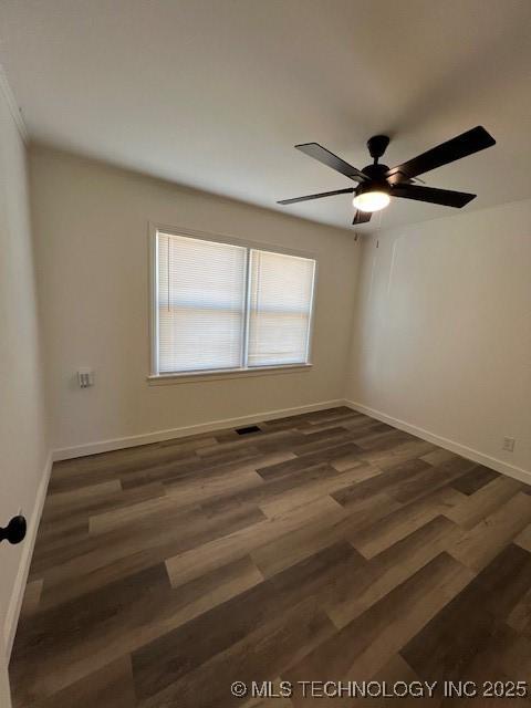 empty room featuring ceiling fan and dark hardwood / wood-style flooring