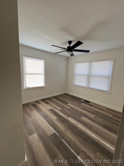 unfurnished room featuring ceiling fan and dark hardwood / wood-style flooring