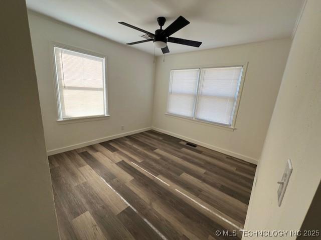 unfurnished room with dark hardwood / wood-style floors and ceiling fan