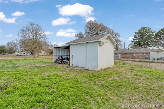 view of outdoor structure featuring a carport and a yard