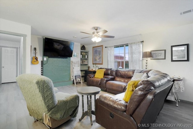 living room with hardwood / wood-style flooring and ceiling fan