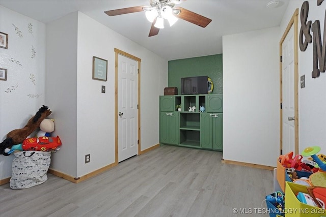 game room with light wood-type flooring and ceiling fan