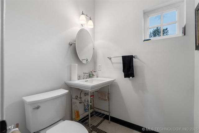 bathroom featuring tile patterned floors, toilet, and sink