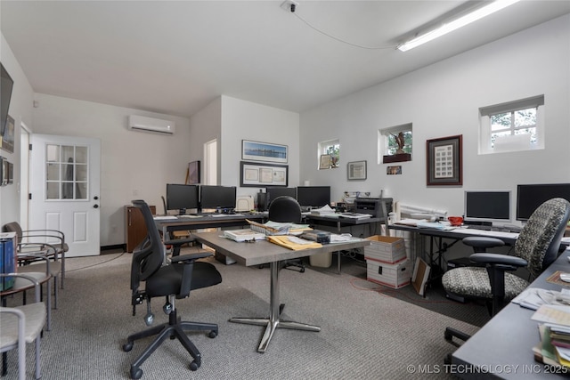 office space featuring an AC wall unit and light colored carpet