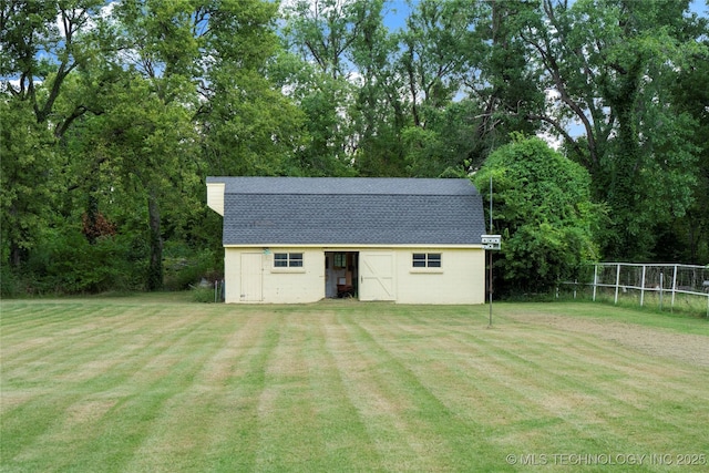 view of outbuilding featuring a lawn