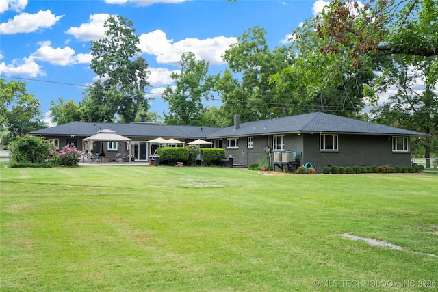 back of property with a lawn