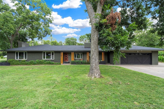 ranch-style house featuring a garage and a front lawn