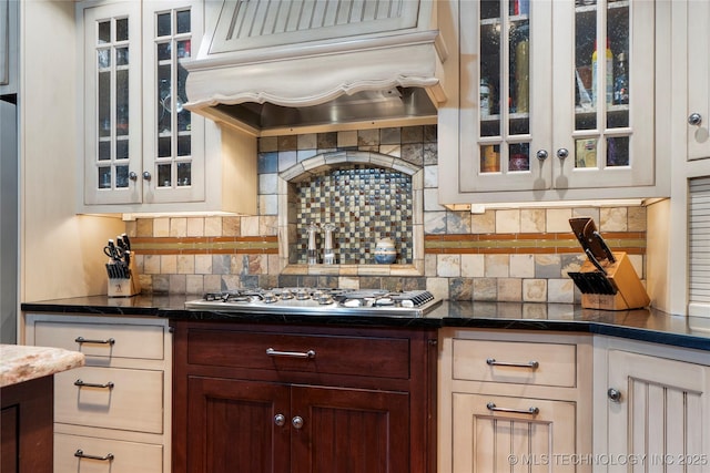 kitchen featuring custom range hood, backsplash, and stainless steel gas stovetop