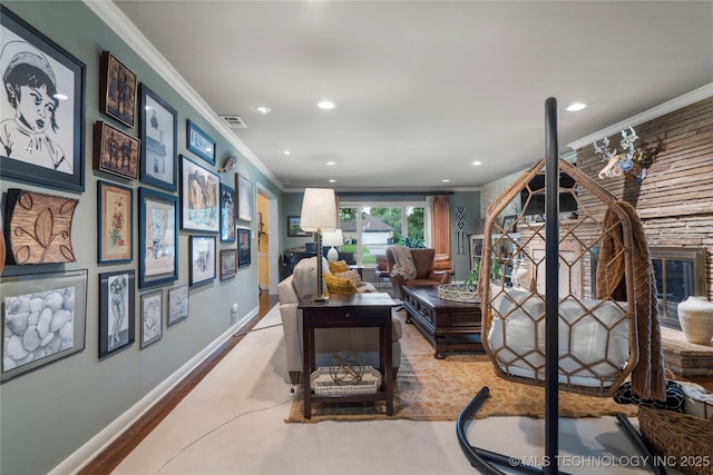 living room featuring crown molding, a fireplace, and light hardwood / wood-style flooring