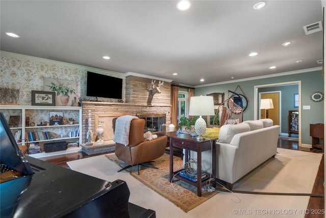 living room with a fireplace and ornamental molding