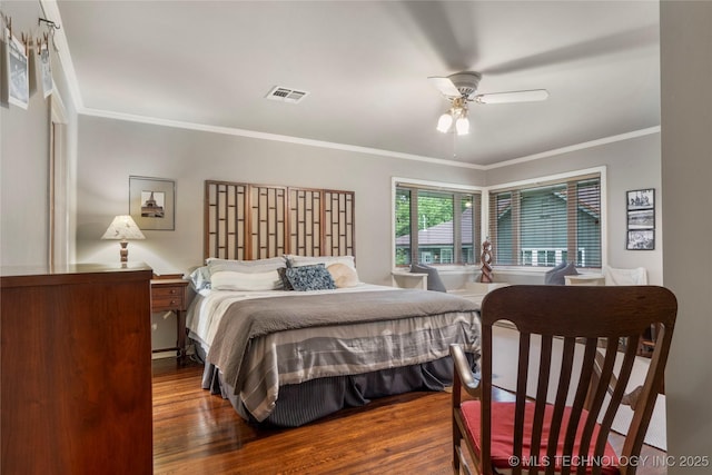 bedroom with dark hardwood / wood-style flooring, ceiling fan, and ornamental molding