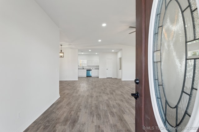 foyer entrance with sink, hardwood / wood-style floors, and ceiling fan