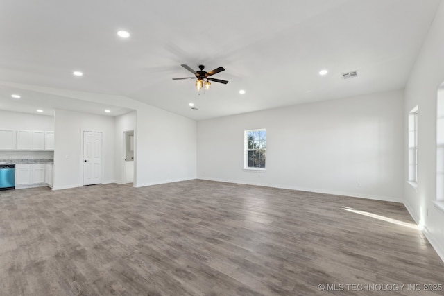 unfurnished living room featuring ceiling fan, lofted ceiling, and light hardwood / wood-style floors