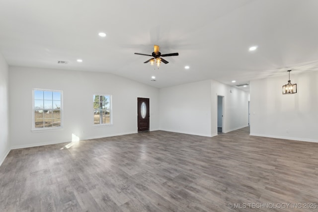 unfurnished living room with wood-type flooring, lofted ceiling, and ceiling fan with notable chandelier