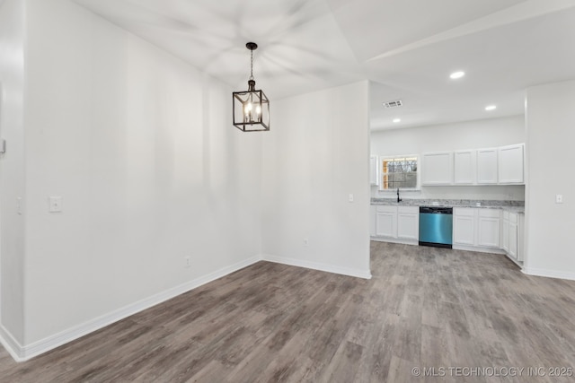 interior space featuring sink, an inviting chandelier, and light hardwood / wood-style flooring