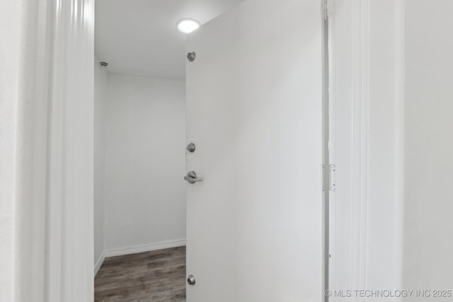 hall with wood finished floors and baseboards