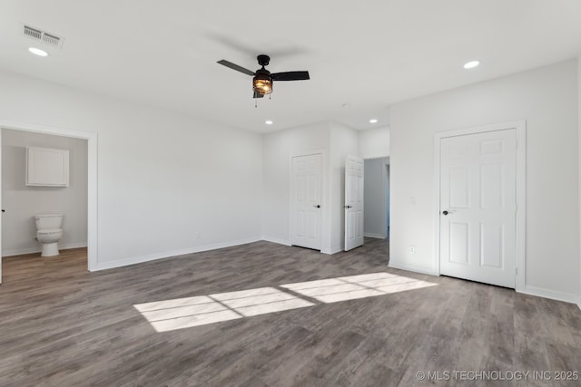 unfurnished bedroom with recessed lighting, visible vents, wood finished floors, and baseboards