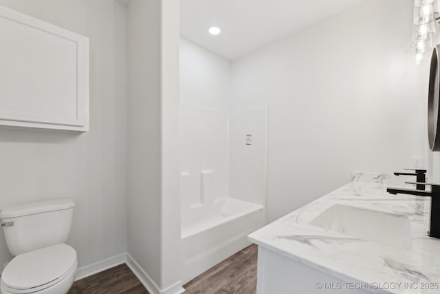 bathroom with vanity, toilet, and hardwood / wood-style floors