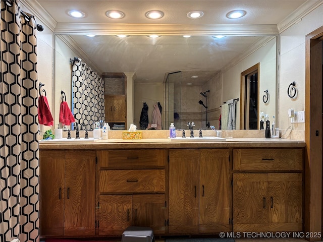 full bathroom featuring ornamental molding, a sink, a tile shower, and double vanity