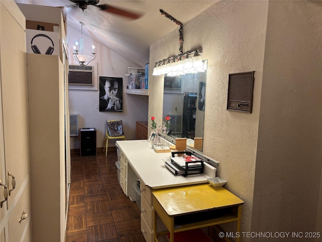 bathroom with a ceiling fan, a textured wall, lofted ceiling, a textured ceiling, and a wall mounted AC