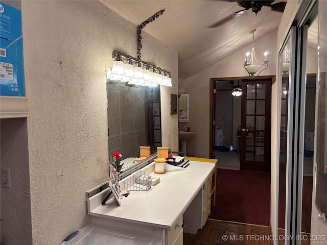 bathroom with ceiling fan, a textured wall, french doors, and lofted ceiling