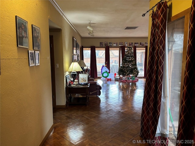 hall featuring crown molding and parquet floors