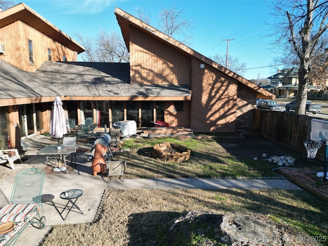 back of property featuring a patio and fence