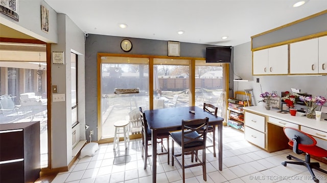 dining room featuring light tile patterned floors, built in desk, and recessed lighting