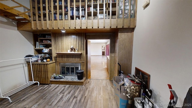 interior space with a glass covered fireplace and wood finished floors