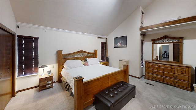 bedroom featuring light carpet, baseboards, and vaulted ceiling