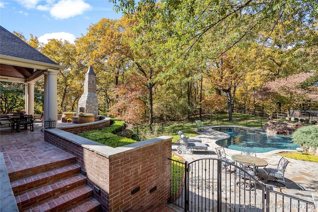 exterior space with a patio area and exterior fireplace