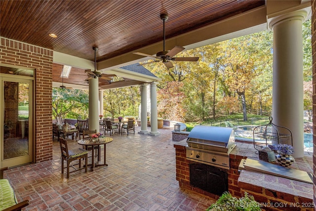 view of patio with grilling area, ceiling fan, and exterior kitchen