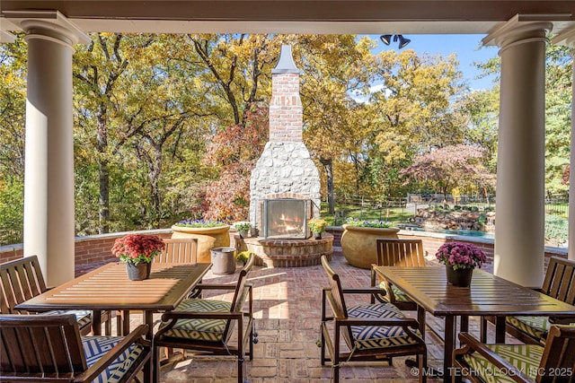 view of patio featuring an outdoor stone fireplace