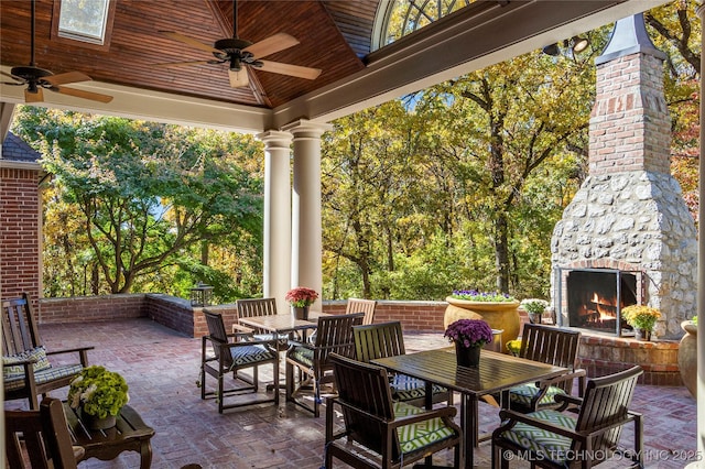 view of patio / terrace featuring an outdoor stone fireplace and ceiling fan