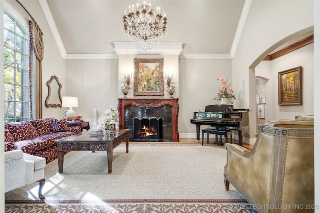 living room featuring a fireplace, a chandelier, a wealth of natural light, and ornamental molding