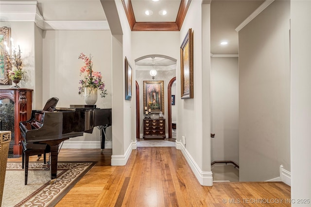 corridor featuring wood-type flooring and ornamental molding