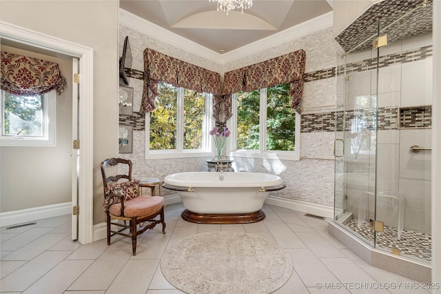 bathroom with tile patterned floors, separate shower and tub, crown molding, and an inviting chandelier