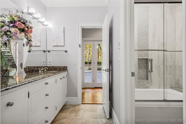 bathroom featuring shower / bath combination with glass door, crown molding, tile patterned flooring, and vanity