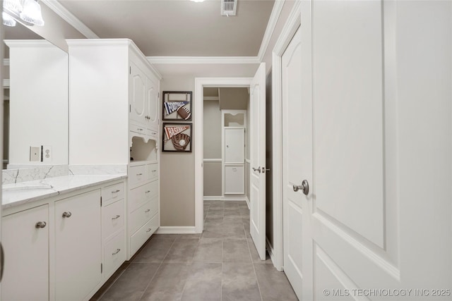 bathroom with tile patterned flooring, vanity, and ornamental molding