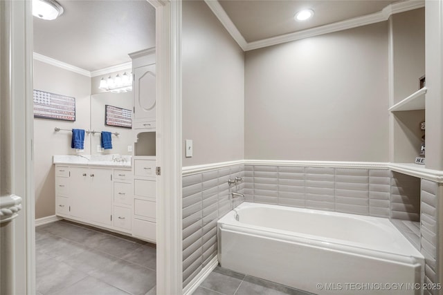 bathroom featuring a washtub, vanity, tile patterned floors, and ornamental molding