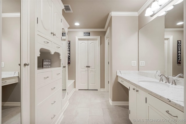 bathroom featuring tile patterned floors, vanity, ornamental molding, and a bath