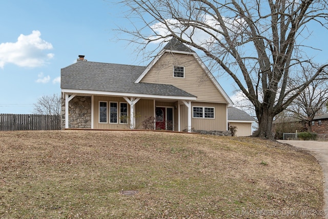 view of front of property with a front yard and covered porch