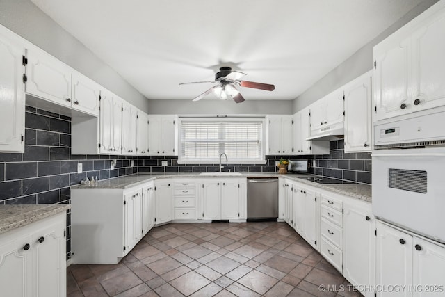 kitchen featuring sink, white cabinetry, stainless steel dishwasher, white oven, and backsplash