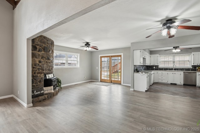 201 Sandy Cir, Tahlequah, OK 74464 - unfurnished living room featuring a ceiling fan, wood finished floors, and baseboards