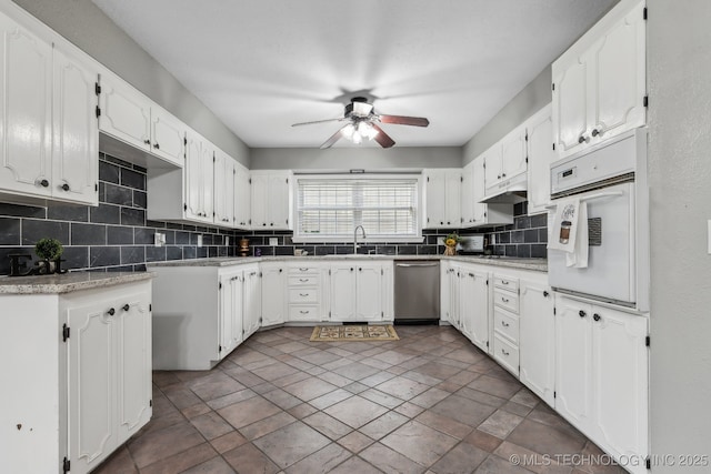 201 Sandy Cir, Tahlequah, OK 74464 - kitchen featuring dishwasher, oven, backsplash, ceiling fan, and a sink